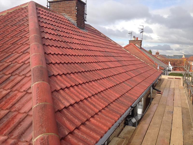 A freshly re-tiled red pantile roof by Top Level Roofing
