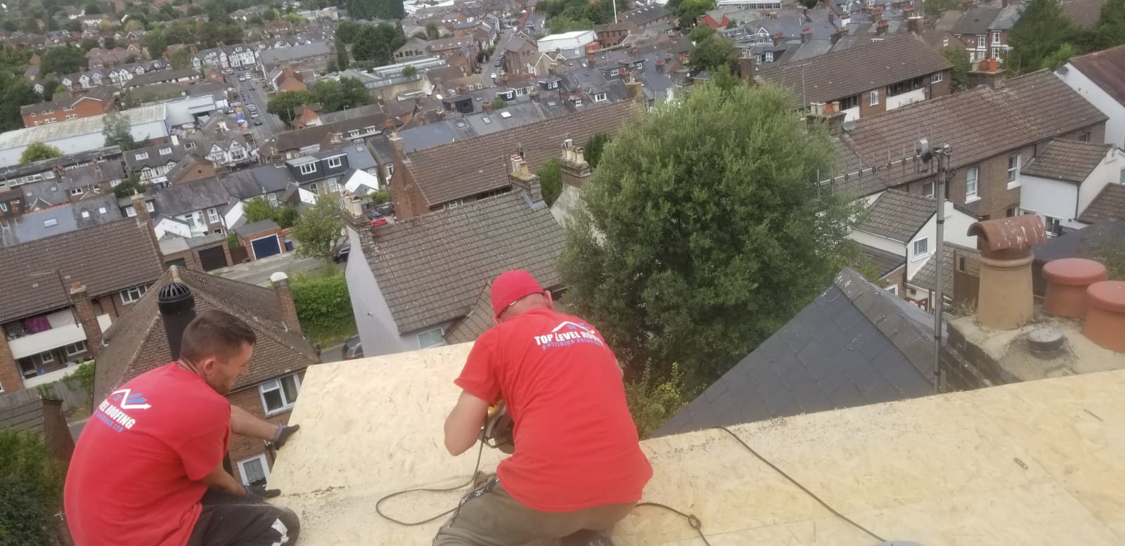 The Top Level Roofing team working together on a re-roof