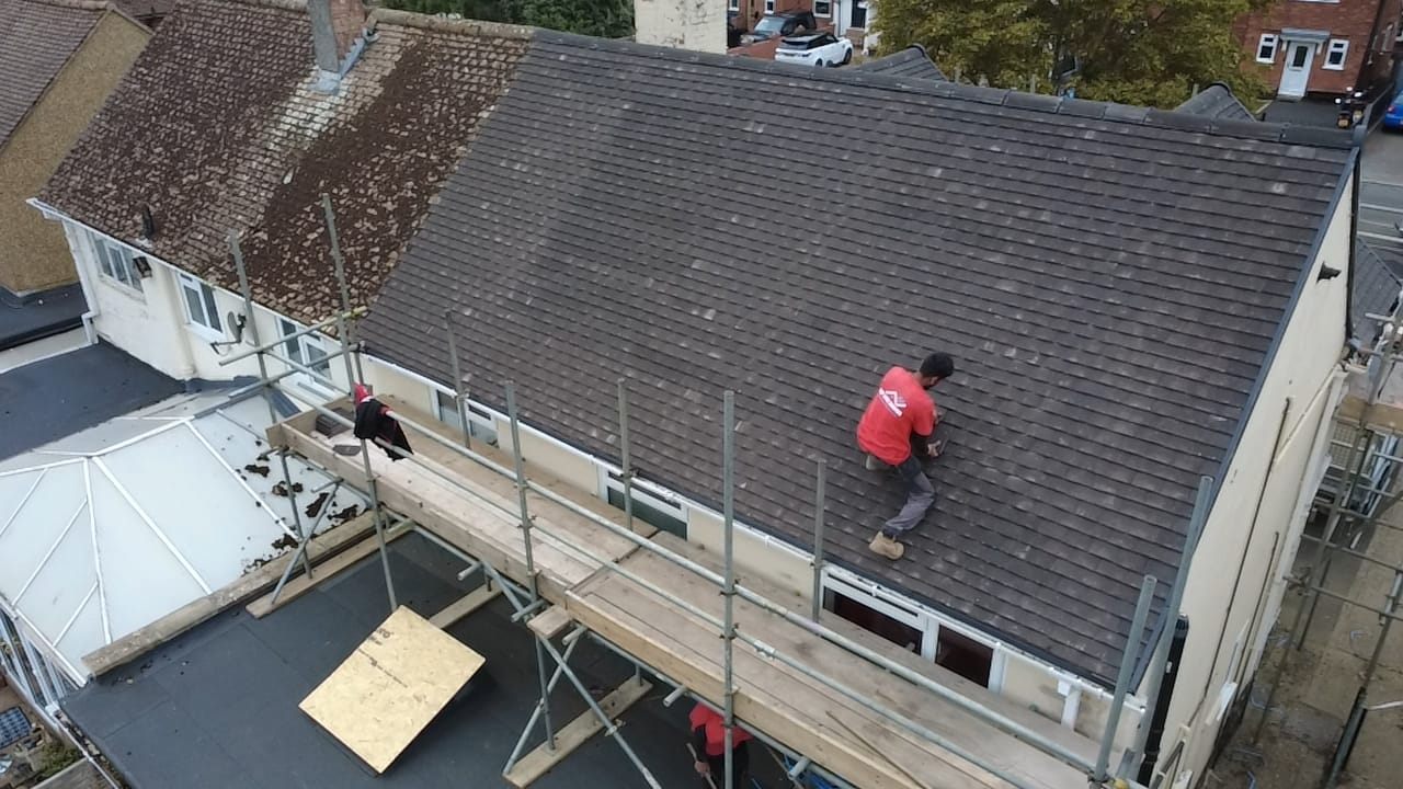 Aerial view of a completed double-gable tiled roof by Top Level Roofing & Building Solutions