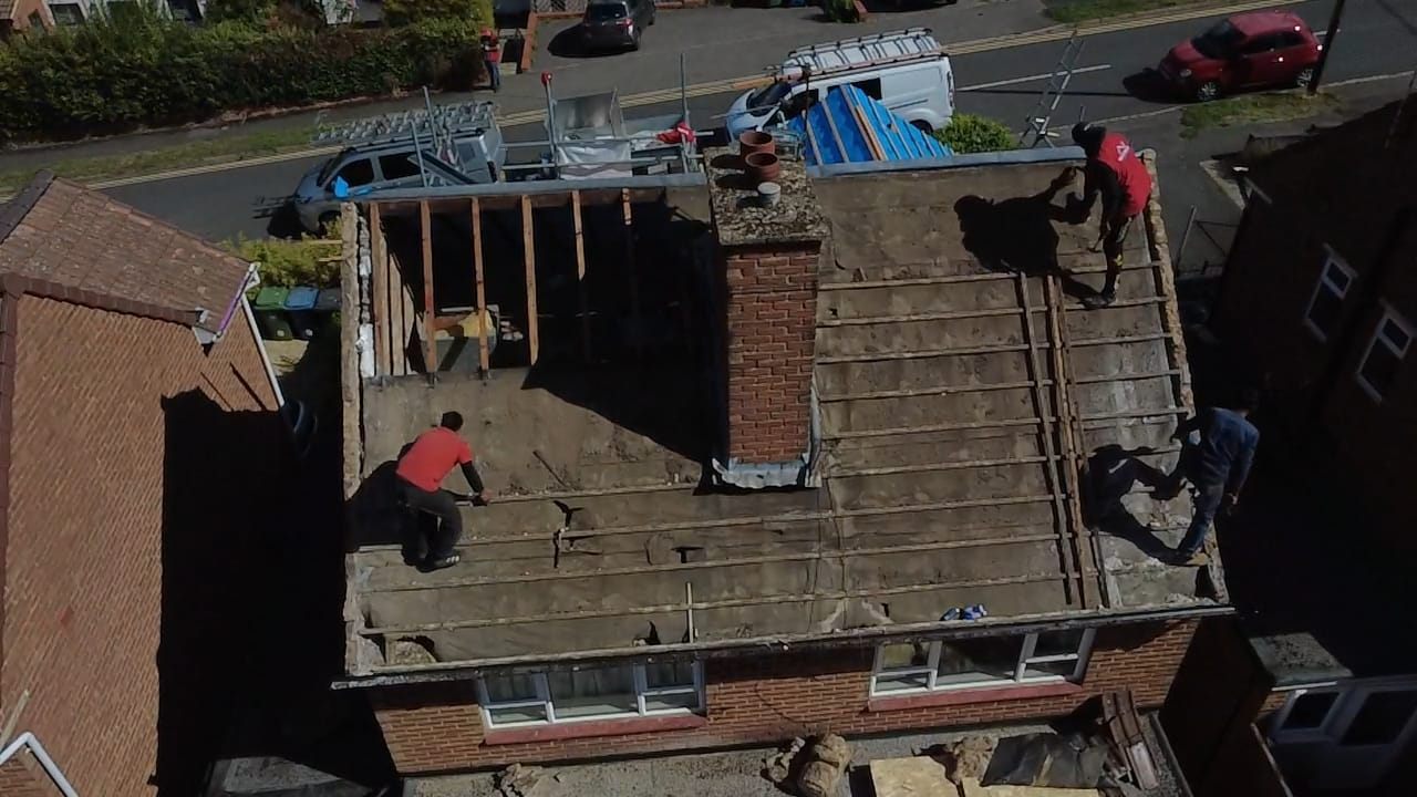 Aerial view of a roof strip in progress with the team on site by Top Level Roofing & Building Solutions
