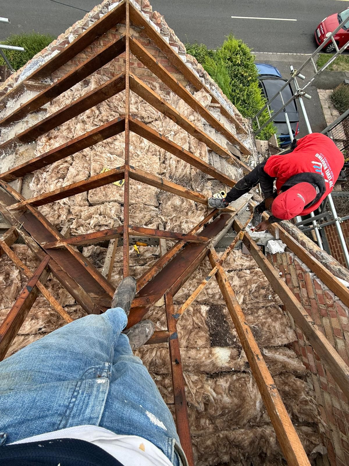 Stripping the old covering from a hipped roof by Top Level Roofing & Building Solutions