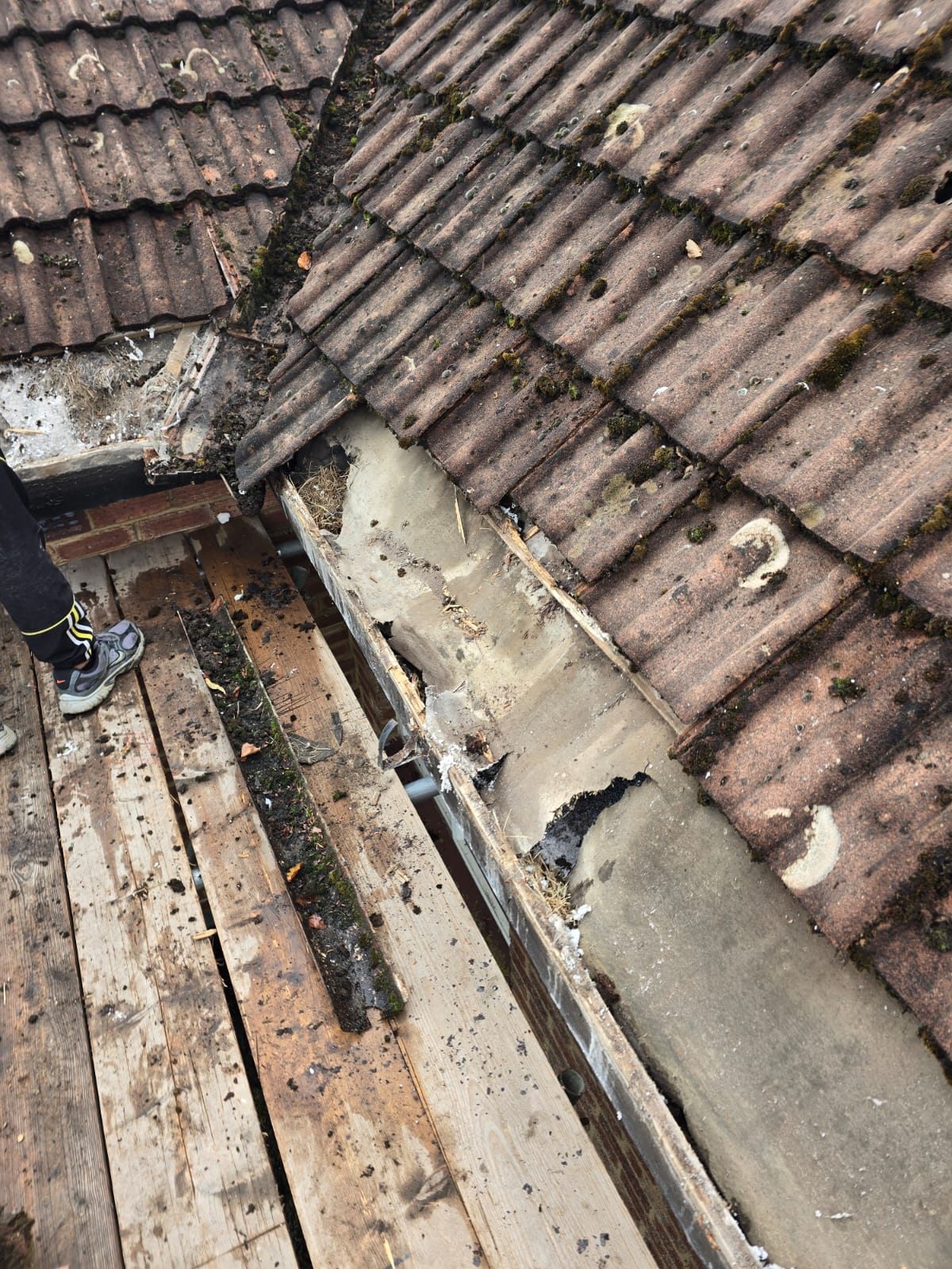 A degraded parapet valley with exposed decking ready for repair by Top Level Roofing & Building Solutions
