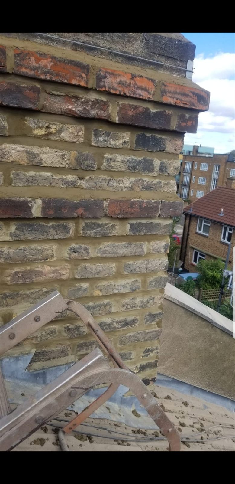 A repointed chimney stack corner with fresh mortar by Top Level Roofing & Building Solutions