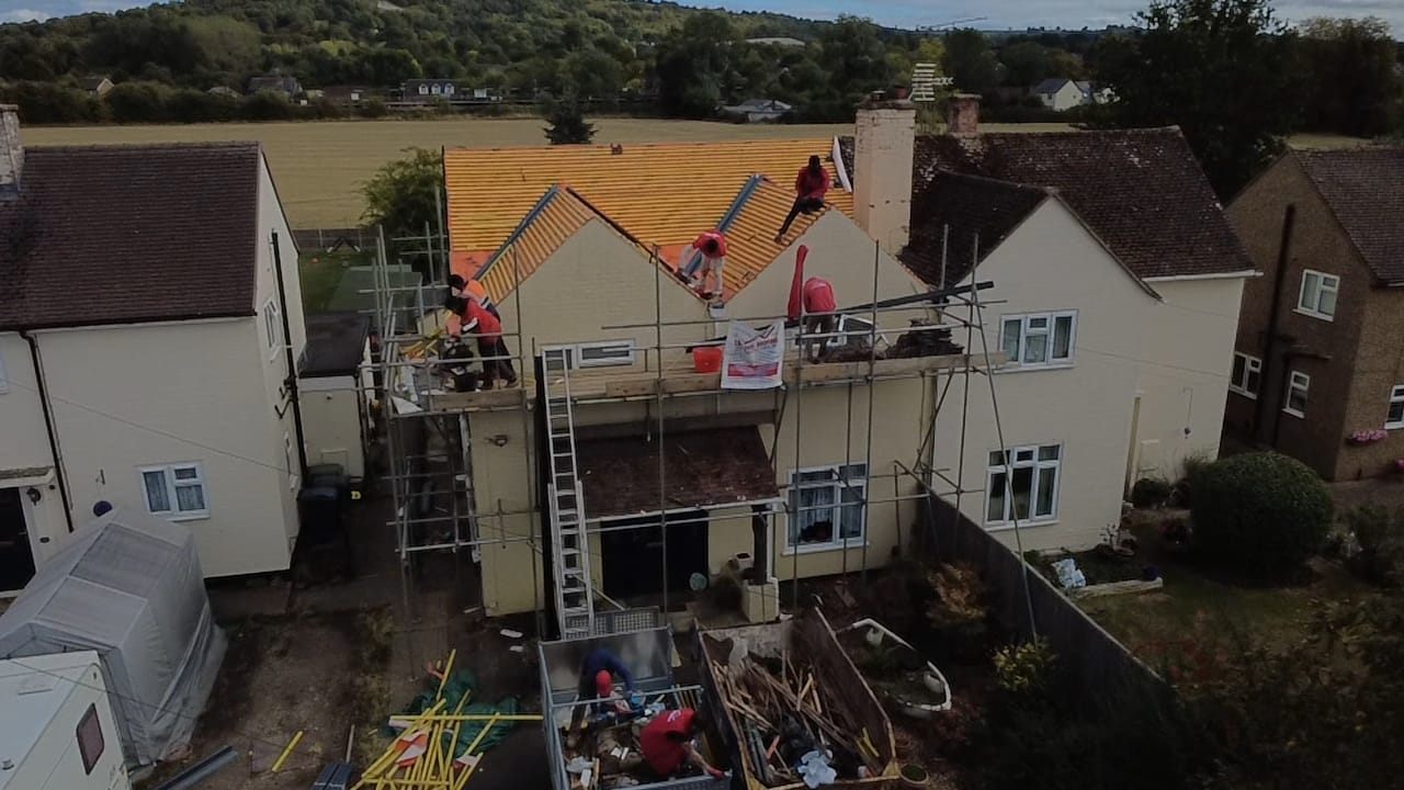 Aerial view of a full re-roof in progress with the team on scaffold by Top Level Roofing & Building Solutions